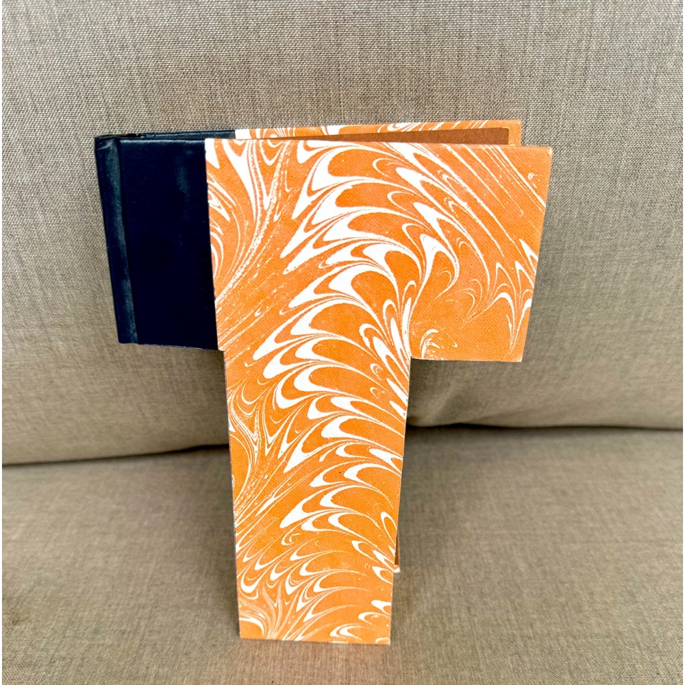 Initial “T” made out of a Book